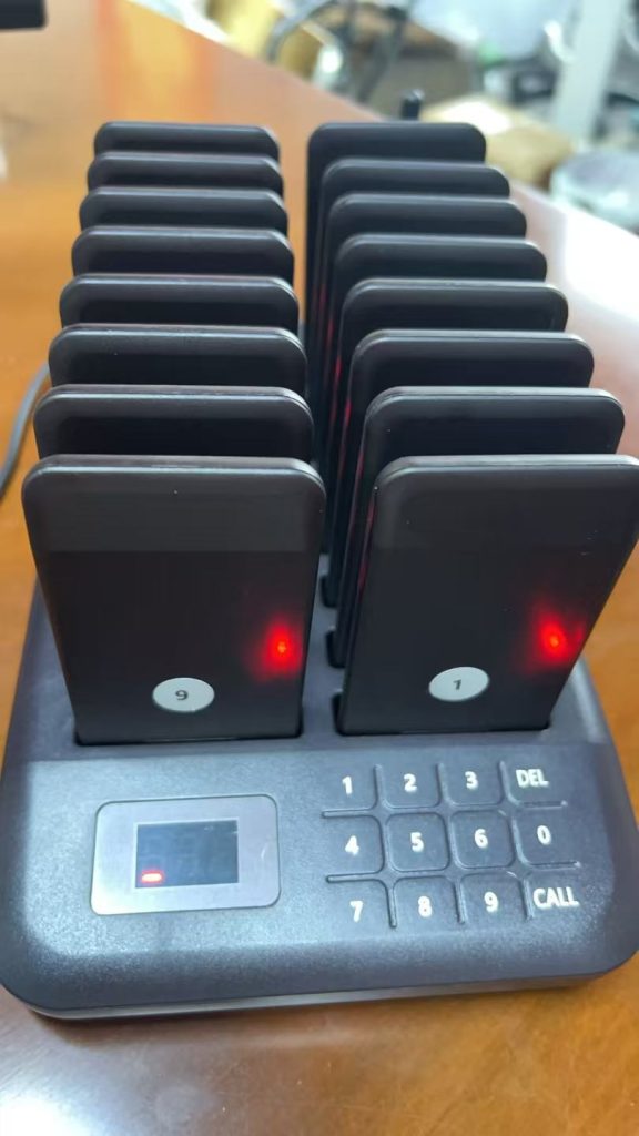 STMITE restaurant pager base with numbered wireless guest pagers for pickup workflow